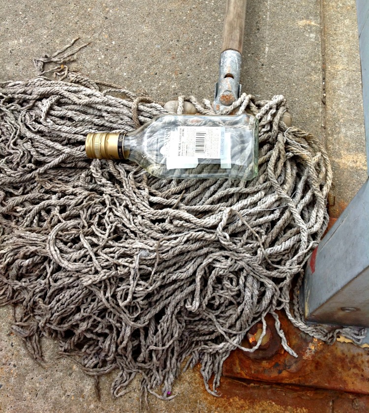 Yo-ho and a bottle of rum.  And a mop.  This was lying on the platform of the train station.  I think it looks quite artsy, don't you? I'm calling in Rum on a Mop.